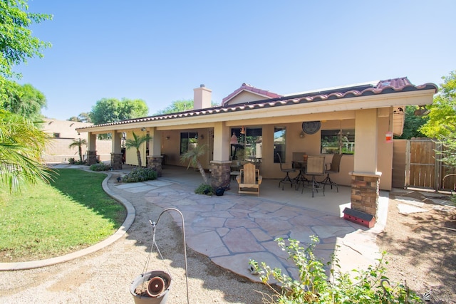 back of house with a patio