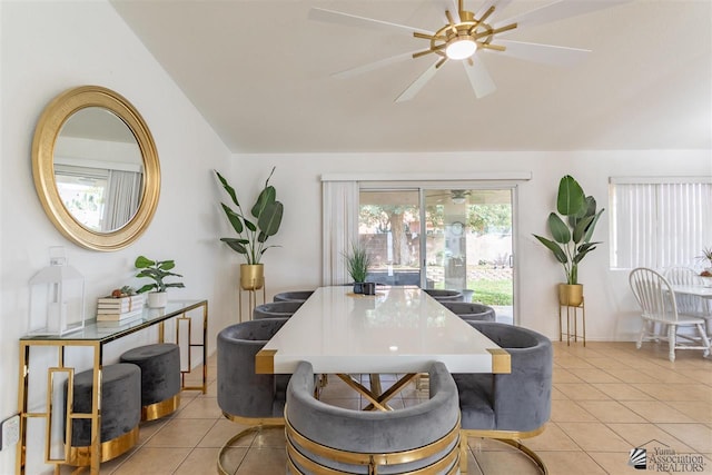 dining area featuring ceiling fan, lofted ceiling, and light tile patterned floors