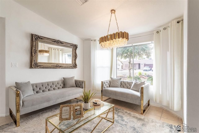 living room with an inviting chandelier and tile patterned floors