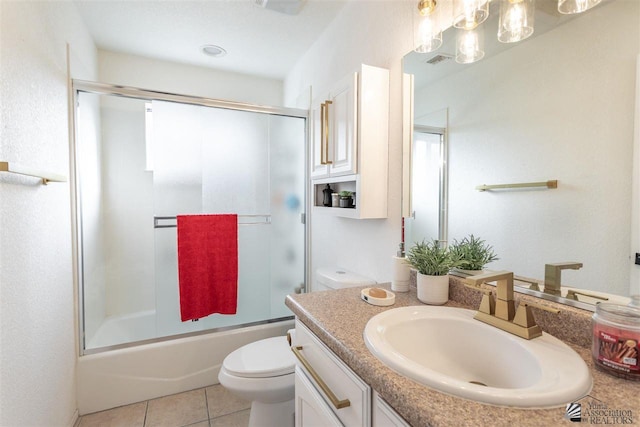 full bathroom featuring vanity, tile patterned floors, enclosed tub / shower combo, and toilet