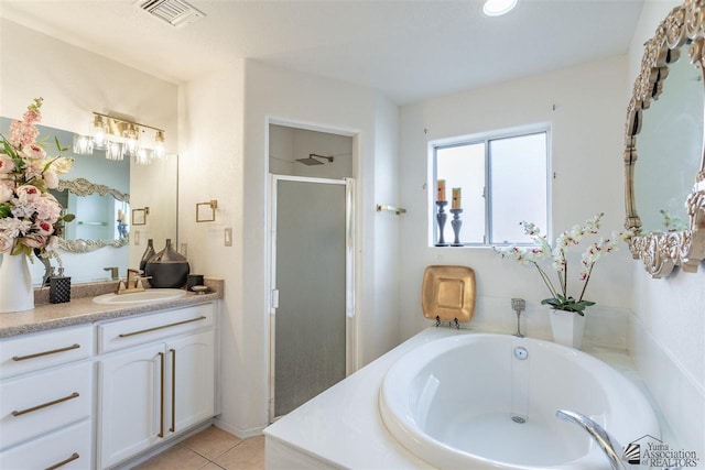 bathroom with vanity, tile patterned floors, and plus walk in shower