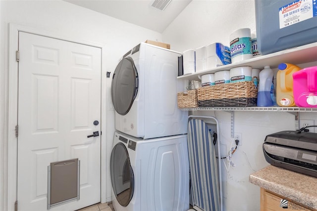 laundry area featuring stacked washer and dryer