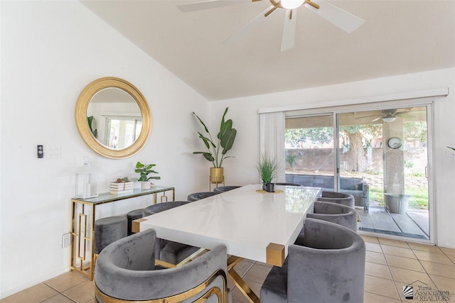 dining area featuring lofted ceiling, ceiling fan, and light tile patterned flooring