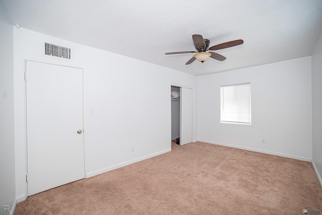 unfurnished bedroom featuring ceiling fan and light carpet