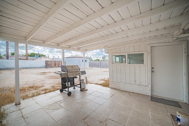 view of patio / terrace featuring area for grilling and a storage unit