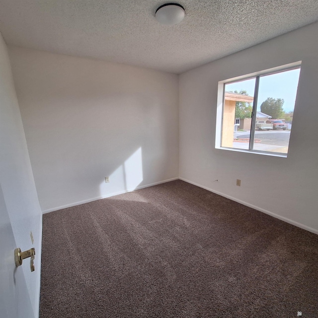 carpeted spare room featuring a textured ceiling