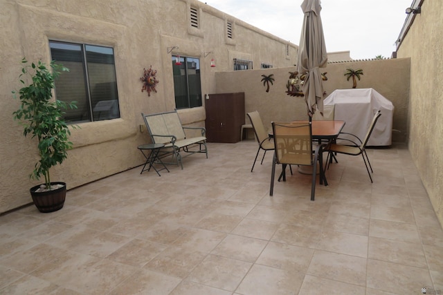 view of patio featuring fence and outdoor dining space