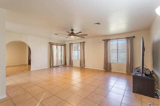 empty room with light tile patterned floors and ceiling fan