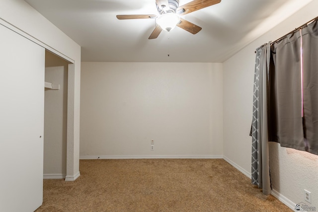 unfurnished bedroom with ceiling fan and light carpet