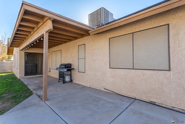 view of patio with central AC unit and a grill