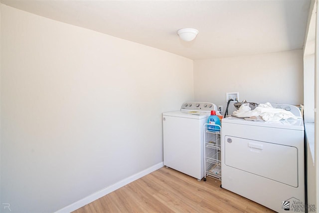 washroom featuring separate washer and dryer and light hardwood / wood-style flooring