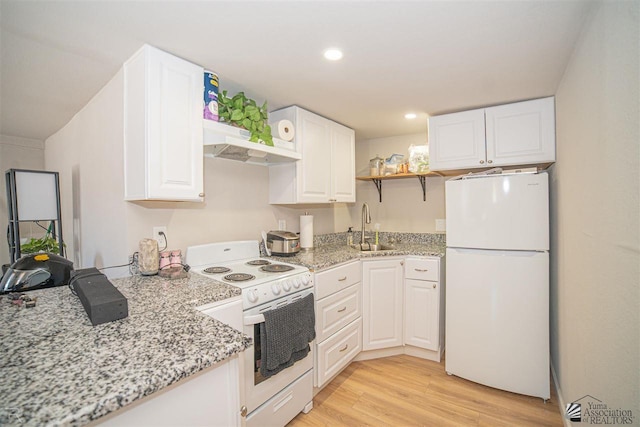 kitchen with light wood-type flooring, white appliances, extractor fan, sink, and white cabinetry