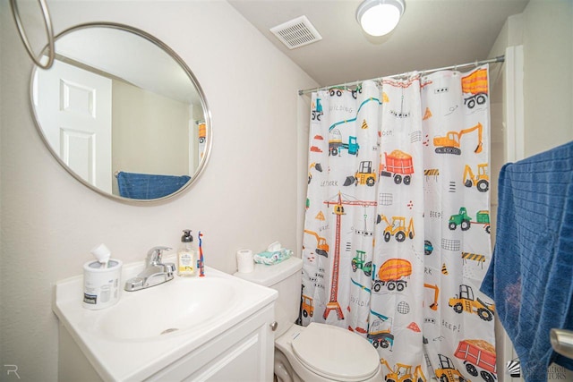 bathroom with vanity, a shower with shower curtain, and toilet