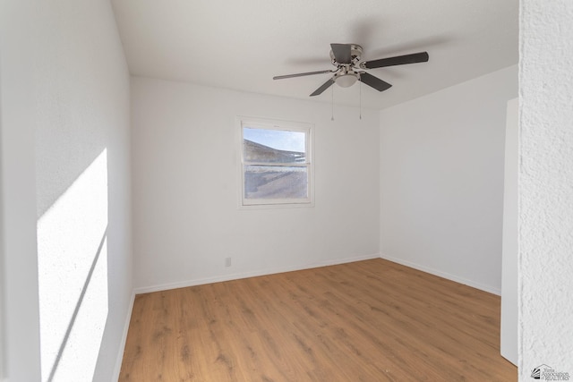 spare room with hardwood / wood-style floors and ceiling fan