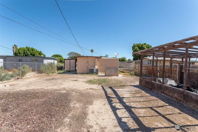 view of yard with central AC unit and an outdoor structure