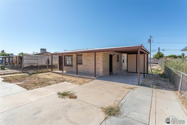 view of front of house with central AC and a carport