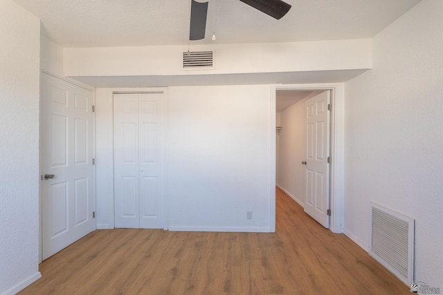 unfurnished bedroom with a closet, ceiling fan, and light hardwood / wood-style flooring