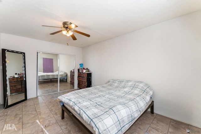 tiled bedroom featuring a closet and ceiling fan