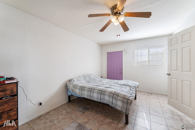 tiled bedroom featuring ceiling fan