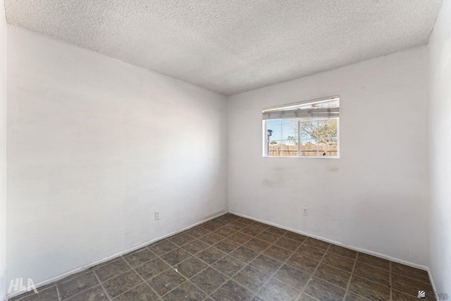 empty room with a textured ceiling