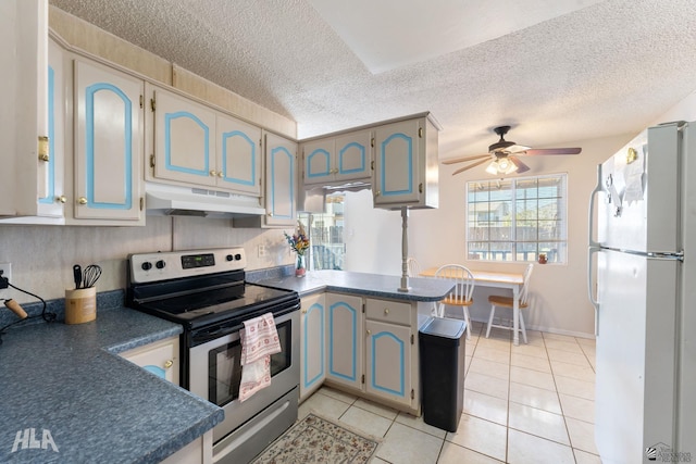 kitchen featuring a textured ceiling, stainless steel range with electric cooktop, ceiling fan, white refrigerator, and light tile patterned flooring