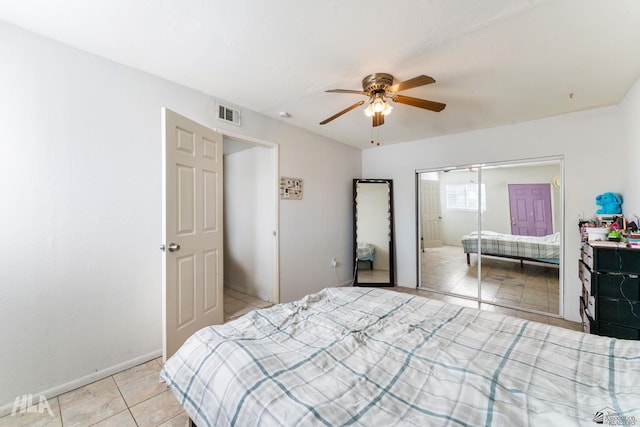 tiled bedroom featuring ceiling fan