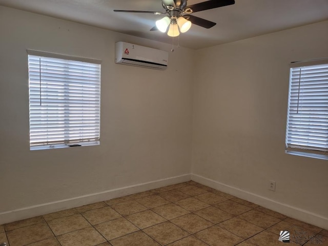 tiled spare room featuring an AC wall unit and ceiling fan