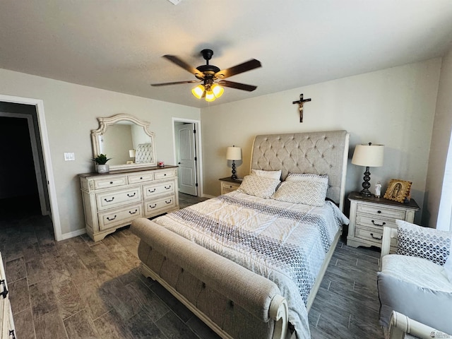 bedroom with ceiling fan, baseboards, and wood finish floors