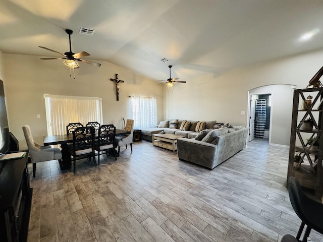 living room featuring visible vents, wood finished floors, a ceiling fan, and arched walkways