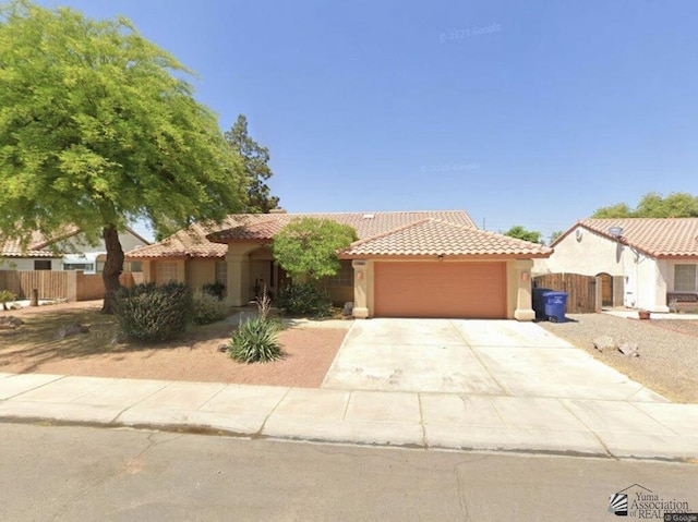 mediterranean / spanish-style home with a garage