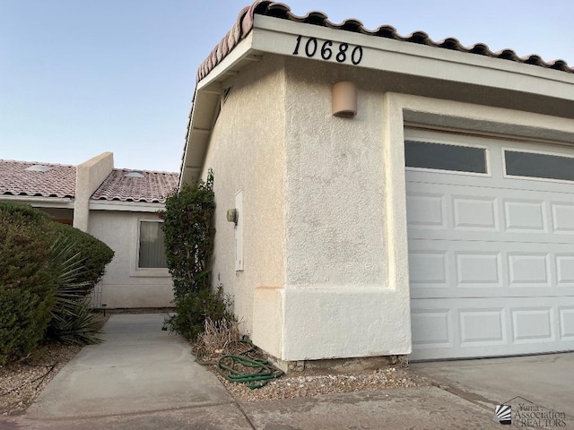 view of side of home featuring a garage