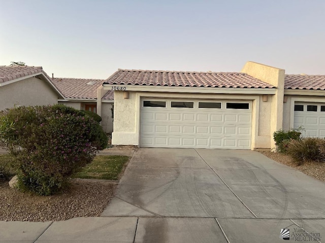 mediterranean / spanish-style house with a garage