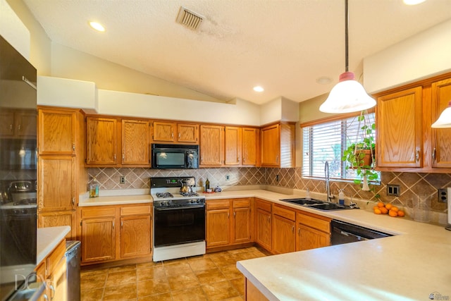 kitchen with black appliances, vaulted ceiling, pendant lighting, and sink