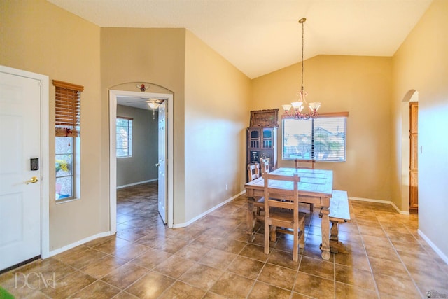 dining area with a chandelier and lofted ceiling