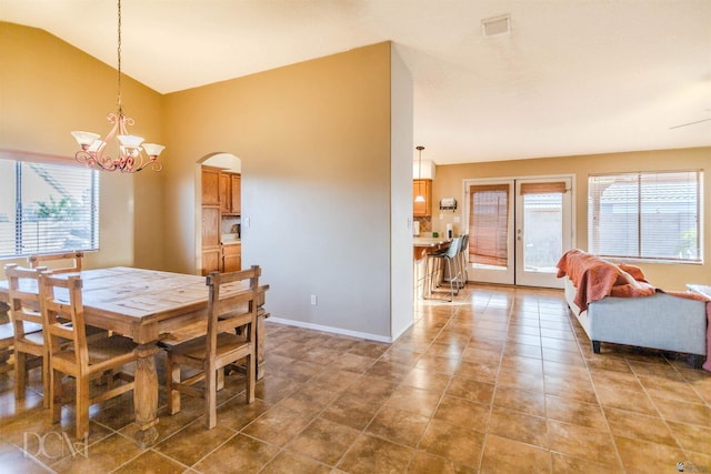 dining space featuring a notable chandelier and lofted ceiling