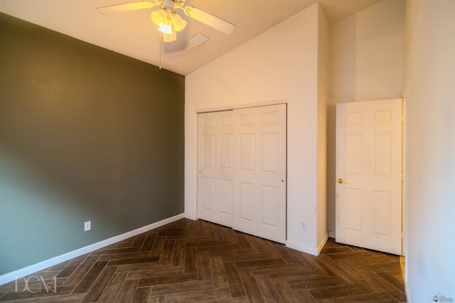 unfurnished bedroom featuring ceiling fan, a closet, and dark parquet floors