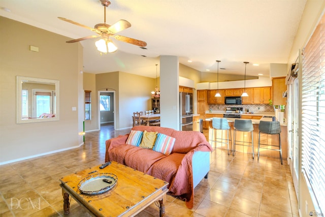 living room with ceiling fan with notable chandelier, light tile patterned floors, and lofted ceiling