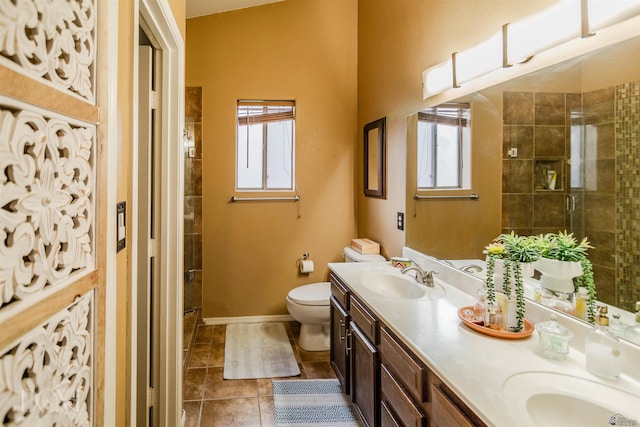 bathroom with a wealth of natural light, toilet, walk in shower, and vanity