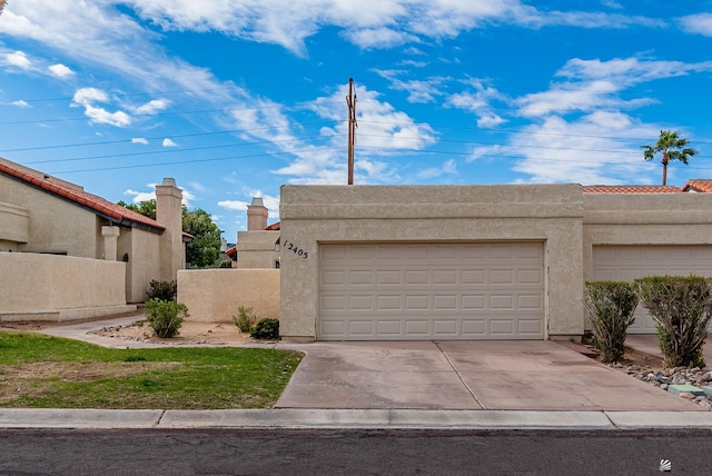 garage featuring driveway and fence