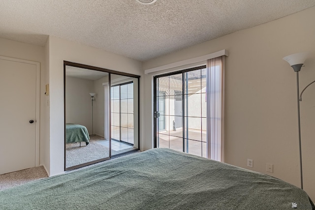 unfurnished bedroom with a closet, a textured ceiling, access to exterior, and carpet flooring