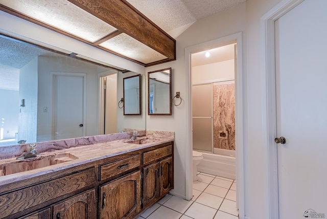 full bathroom featuring tile patterned flooring, toilet, a sink, and a textured ceiling