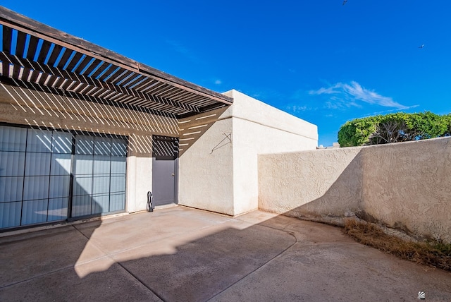 view of patio featuring a pergola and fence