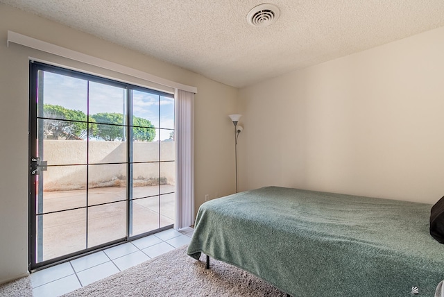 tiled bedroom with visible vents, carpet floors, a textured ceiling, and access to exterior