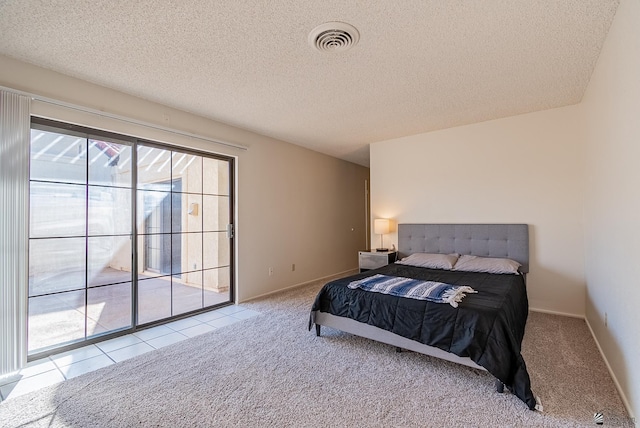 carpeted bedroom featuring visible vents, a textured ceiling, and baseboards