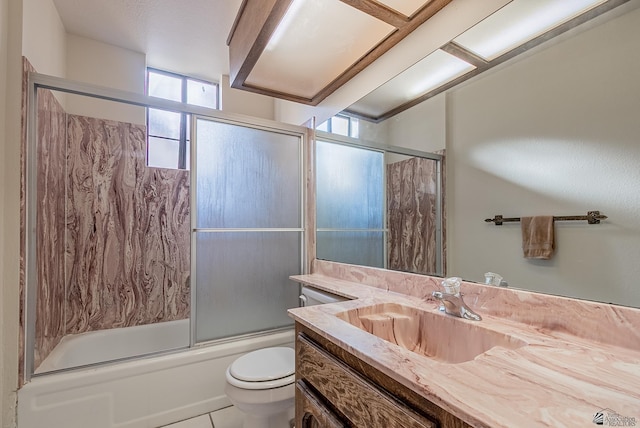 full bathroom with vanity, tile patterned floors, toilet, and enclosed tub / shower combo