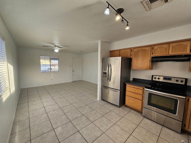 kitchen featuring light tile patterned flooring, ceiling fan, stainless steel appliances, and a textured ceiling