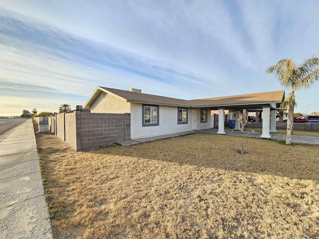 ranch-style house with a front lawn