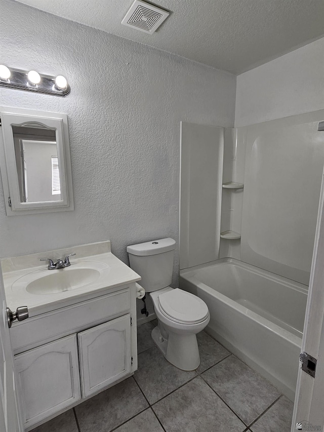 full bathroom with shower / bathing tub combination, vanity, a textured ceiling, toilet, and tile patterned floors