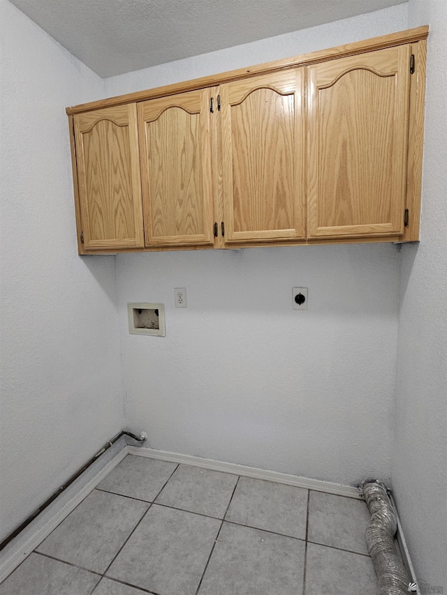 laundry area with cabinets, light tile patterned floors, hookup for an electric dryer, and hookup for a washing machine