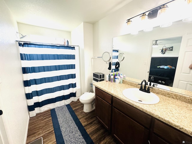 bathroom featuring hardwood / wood-style floors, vanity, and toilet